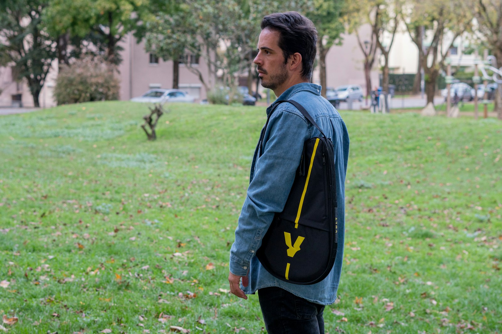 A man standing in a field with a backpack on his back